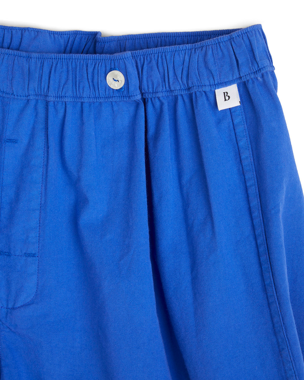 Closeup of Bye Boxers logo on blue shorts