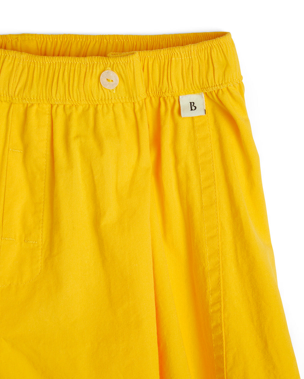 Closeup of Bye Boxers logo on yellow shorts